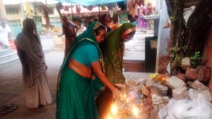 Varanasi, pellegrine offrono lumini al tempietto interno al Nilkan Temple.